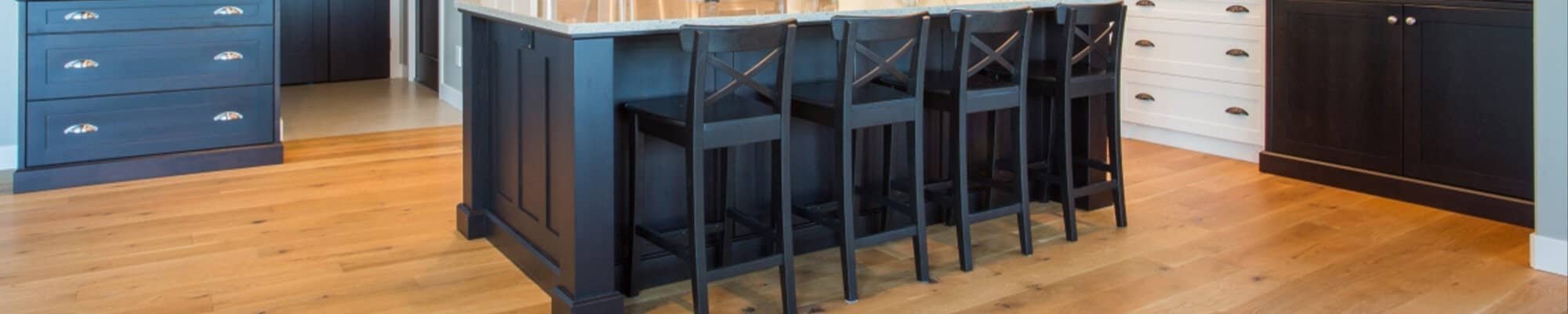 hardwood floors in traditional style kitchen with blue cupboards by American Flooring in Lansing-East Lansing, MI