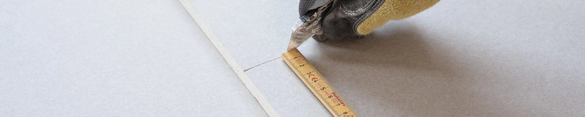 skilled professional measuring tile at American Flooring in Lansing-East Lansing, MI