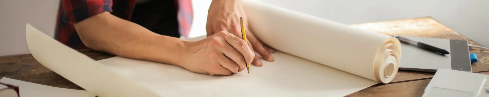 skilled professional drawing home renovation plans at American Flooring in Lansing-East Lansing, MI